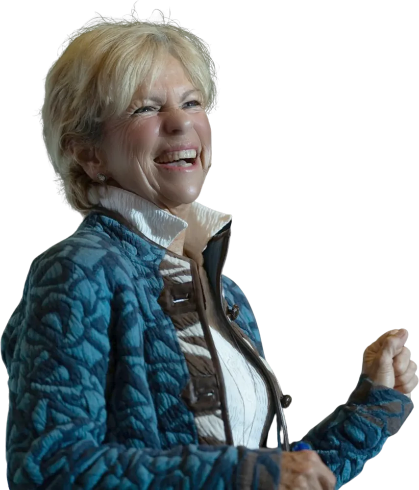 Amanda Gore, leadership speaker, laughing in a blue quilted jacket