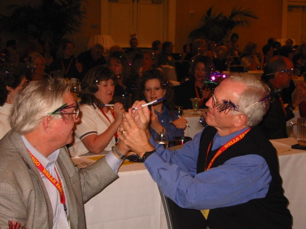 Two men in the audience at an Amanda Gore keynote, laughing as they do an exercise together