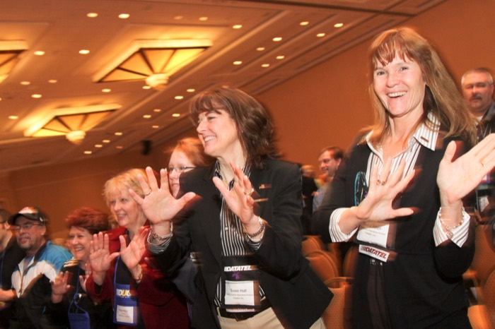 Women in the audience laughing and clapping at an Amanda Gore keynote