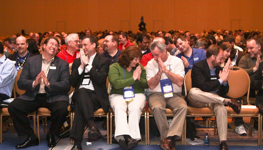 Business people in the audience laughing at an Amanda Gore keynote