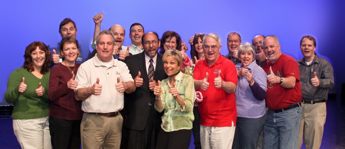 Amanda Gore with a group of conference leaders, all giving a thumbs up